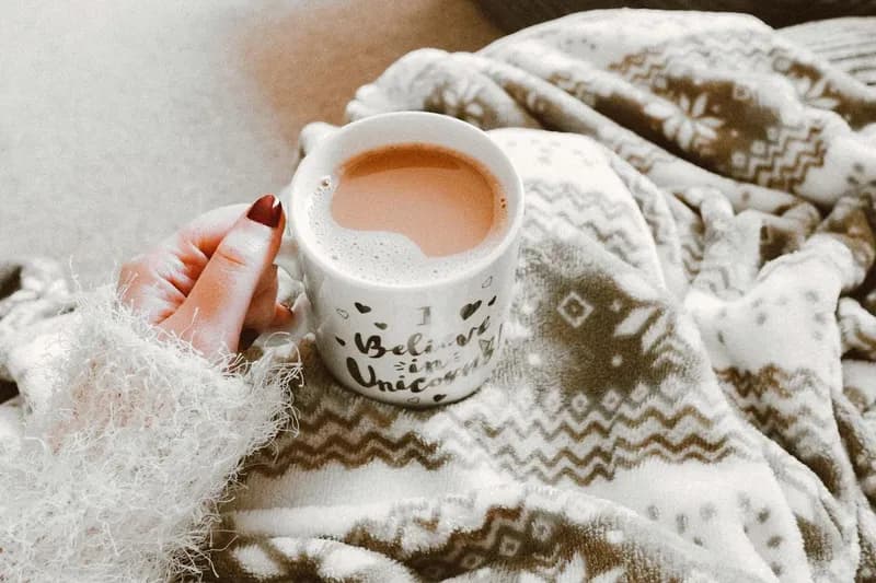 Hands holding a warm mug of cocoa