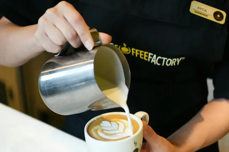 Barista creating latte art in coffee shop