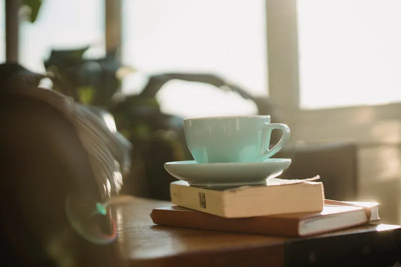 Morning cup with book on a table