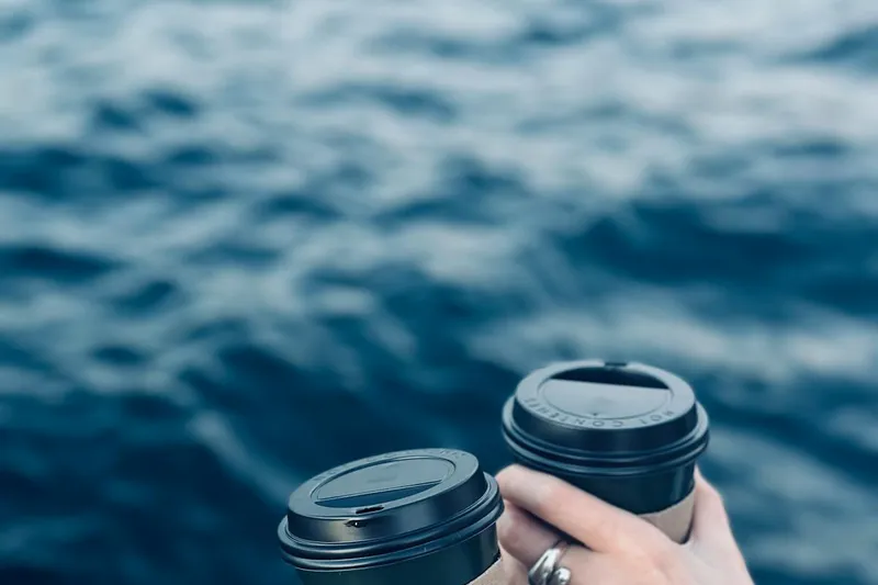 Two hands holding coffee cups